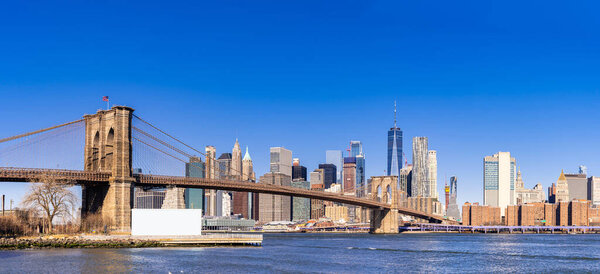 Brooklyn bridge with cityscape of Lower Manhattan skyscrapers skylines bulding New York City in New York State NY , USA. Lower Manhattan is the largest financial district in the world.