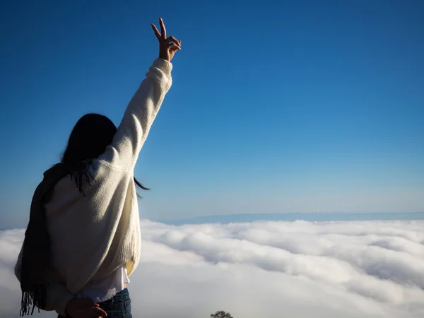 Asiatische Frau drückt ihre Hand nach oben und blickt auf Nebelmeer, Nebelhintergrund — Stockfoto