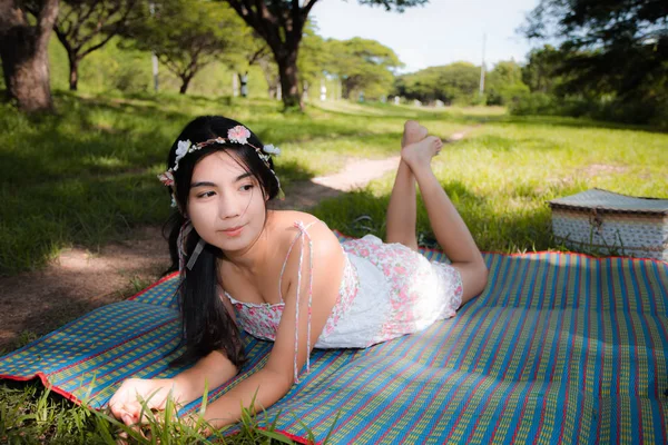 Young asian woman picnic on the meadow