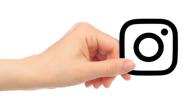 Main tenir icône Instagram isolé sur fond blanc — Photo