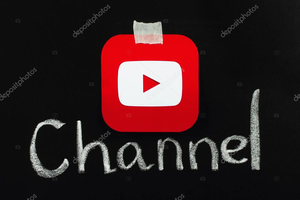 Kiev, Ukraine - September 4, 2017: Youtube icon printed on paper and placed on blackboard with chalk word channel. YouTube is a video-sharing website
