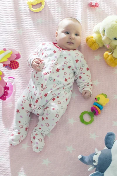 Meisje van de baby in een bed — Stockfoto