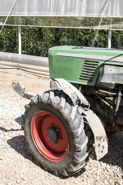 Tractor between greenhouses — Stock Photo, Image