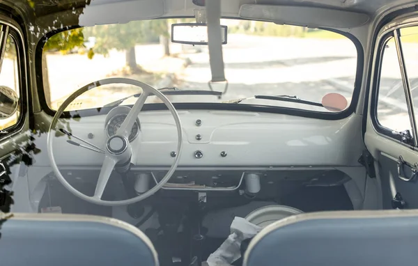 Interior of small white vintage car on the street. No people. Wh — Stock Photo, Image