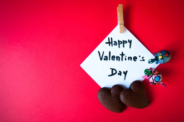 Valentine's card displayed with two chocolate cookies and two small toy turtle — Stock Photo, Image