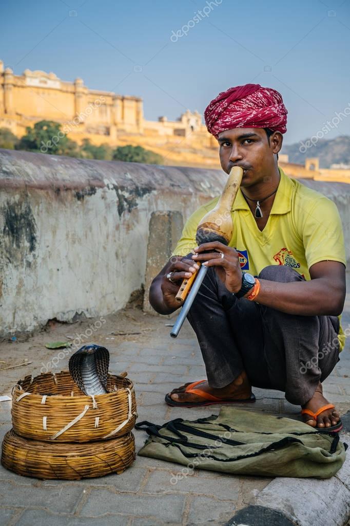 Man playing on flute to cobra snake Stock Editorial Photo © costasd68