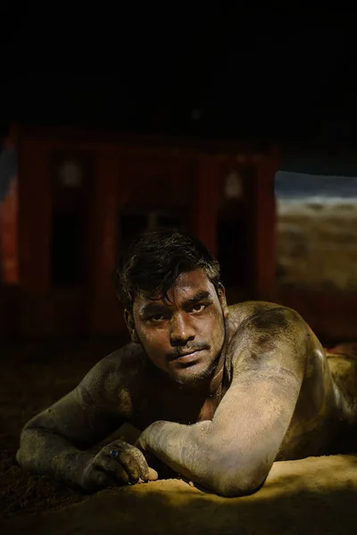 Indian mud wrestler lying on sand — Stock Photo, Image