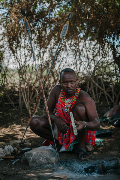 African tribe man squatting