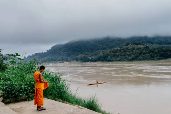 Mönch steht am Ufer des Flusses — Stockfoto