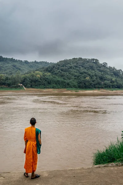 Buddhistmunk stående på flodstranden — Stockfoto
