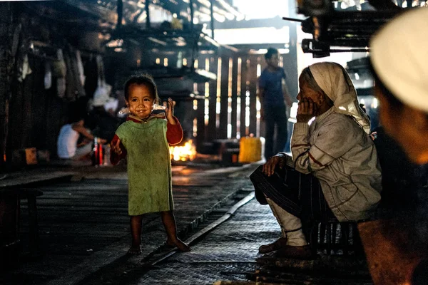 Senior woman and child in village hut — Stock Photo, Image