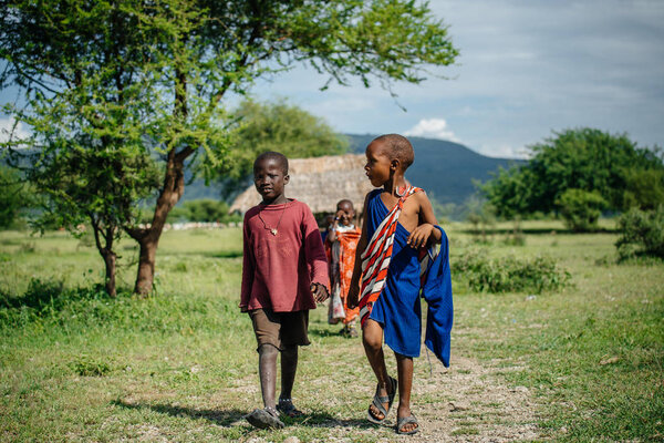 Children of tribe walking towards camera