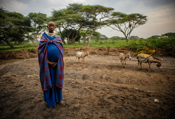 Pregnant tribe woman in traditional clothing