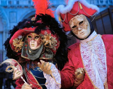 Karnavalda ayakta Venedik maskeli insanlar