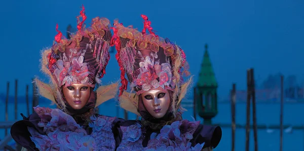 People in venetian masks standing at carnival — Stock Photo, Image