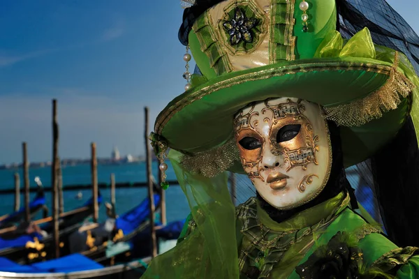 Human in venetian mask standing at carnival