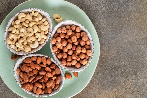 Shelled almonds hazelnuts and cashew above