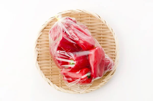Fresh Red Bell Pepper Plastic Bag Bamboo Colander White Background — Stock Photo, Image