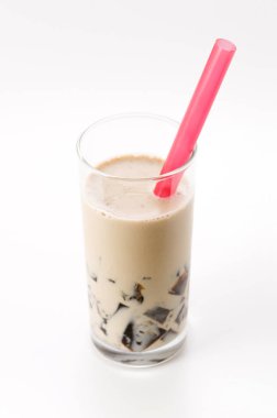 Beyaz arka planda sütlü bir bardak kahve jölesi.