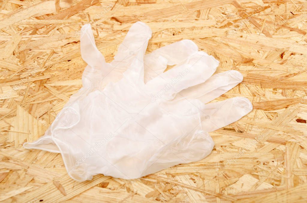 Disposable gloves on a OSB plywood board background