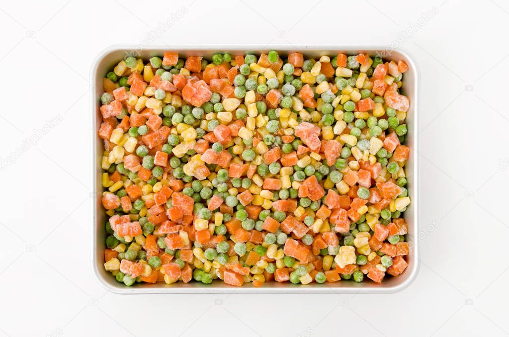 frozen mixed vegetable in a aluminum tray on white background