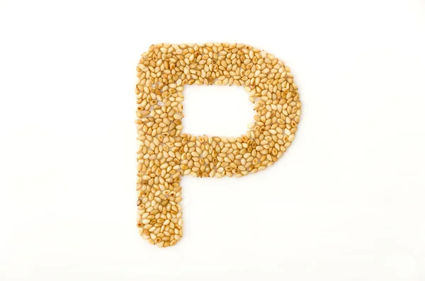 烤芝麻种子字母P大写字母英语字母表分离于白色背景 免版税图库图片