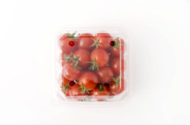 Plastik bir kap içinde kiraz domates. Beyaz arka plan üzerinde kutusunda taze kiraz domates.