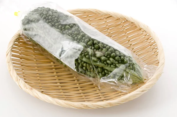 Bitter Melon Plastic Bag Bamboo Colander White Background — 스톡 사진