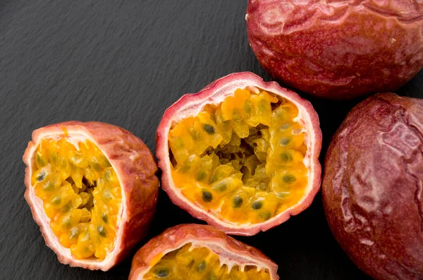 Passion fruit on black stone plate