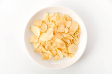 Küçük tabakta kurutulmuş sarımsak cipsi.