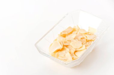 Küçük cam tabakta kurutulmuş sarımsak cipsi.