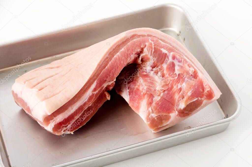 Raw Pork belly on a Aluminum tray on white background