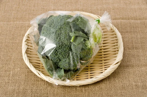 Fresh Broccoli Transparent Plastic Bag Bamboo Sieve Burlap — Stock Photo, Image
