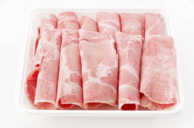 Thin sliced pork boston butt in plastic tray on white background 