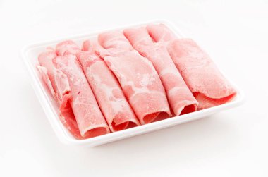 Thin sliced pork boston butt in plastic tray on white background 