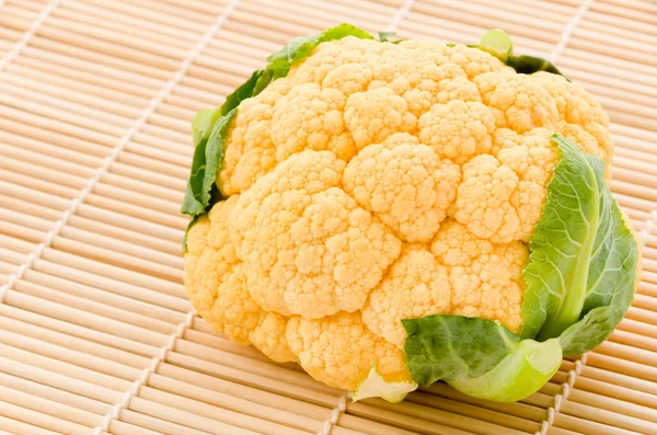 Orangener Blumenkohl Auf Einer Sushi Bambusmatte Auf Weißem Hintergrund — Stockfoto