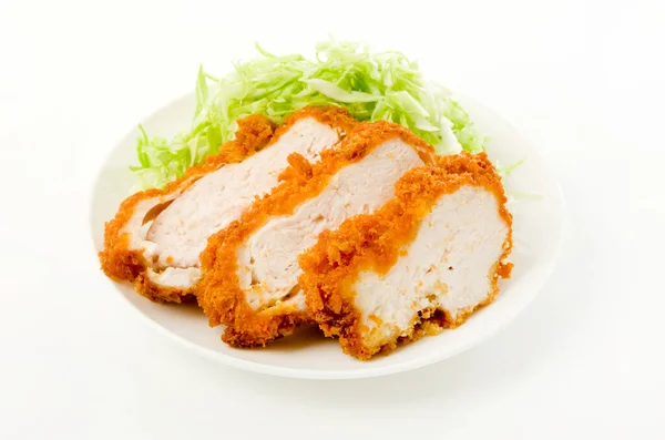 breaded chicken breast with Shredded Cabbage on a white dish on white background