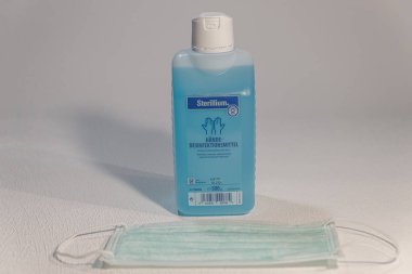 Medical face mask and disinfection solution in a bottle as most 