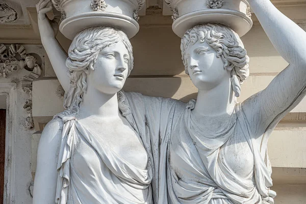 Portrait of balcony support statues of young and naked sensual Roman renaissance era women in Vienna, Austria