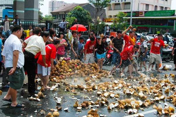 7 Feb 2009 - Georgetown, Penang, Malaysia: Devotees smash coconuts on the ground as an offering to the Hindu deity Murugan durng the annual Thaipusam festival