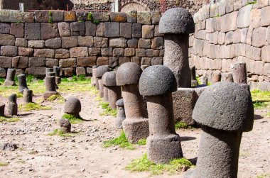 Mushroom-shaped or phallic stone sculptures in the Inca Uyo temple of Puno, Peru clipart