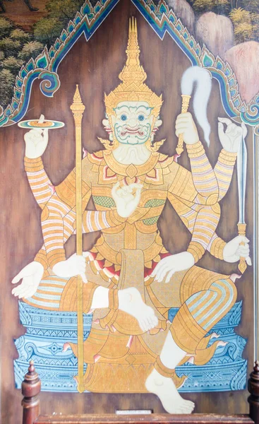 Wall mural in the Grand Palace of Bangkok depicting a guardian figure carrying a sword, discus, flywhisk and staff.