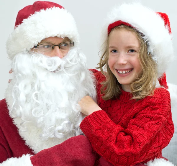 Happy smiling little girl with Santa Claus. — Stock Photo, Image