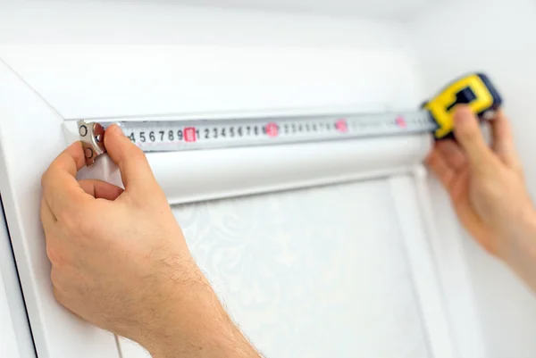 Man installing cassette roller blinds on windows. — Stock Photo, Image