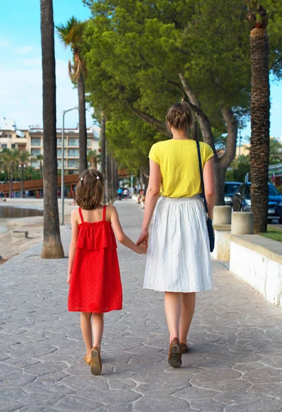 Petite fille et sa mère marchant dans la rue . — Photo