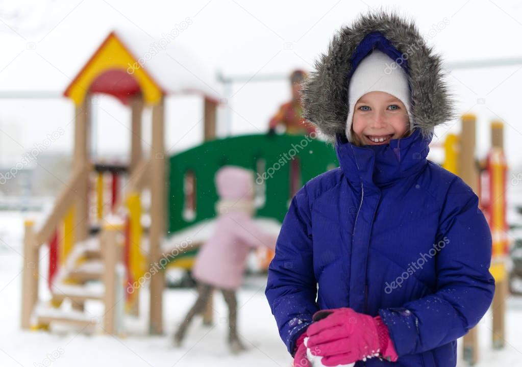 Portrait of happy little girl in winter time.