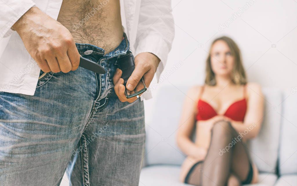 Man taking off his jeans before sex.