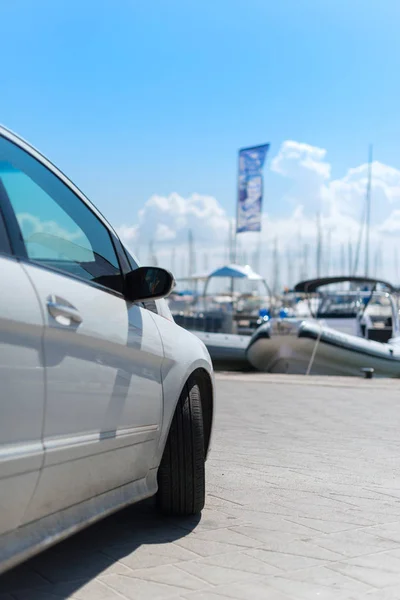 Bilen parkerad nära bredvid piren med båtar. — Stockfoto