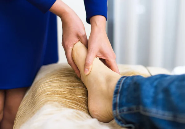 Femme faisant massage des pieds à l'homme à la maison . — Photo