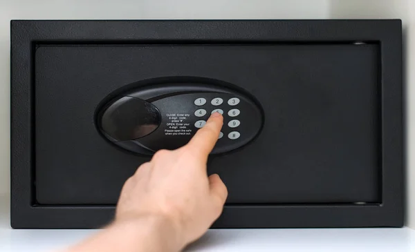 Man's hand opening small safe. — Stock Photo, Image